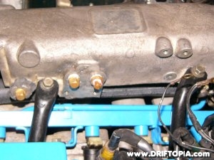 The coolant line runs under the main chamber of the intake manifold on the ca18det.