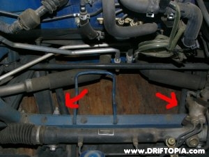 Jpg image showing a stock view of the two factory front lower braces on the mr2 spyder