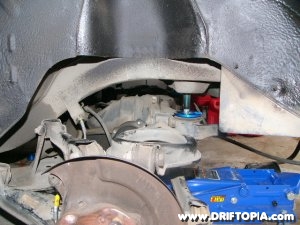 jpg image of the rear subframe being lowered from the nissan 240sx s13