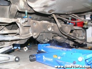jpg image of the rear subframe being lowered on the 240sx