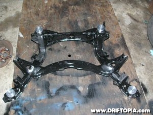 The subframe from the nissan 240sx prepped, painted and with the new bushings installed.