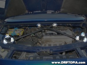 Highlighted image showing the bolts that need to be removed to install the TRD rear strut tower brace on the MR2 Spyder