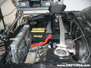 The battery has been relocated in the 240sx’s engine bay for better weight distribution.