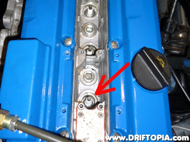 With the coolpack removed, locate and remove the spark plug over cylinder #1. (arrow)