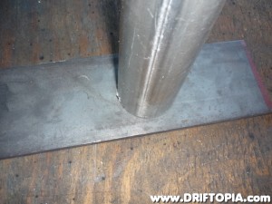 Place the end of the pipe on the steel plate,