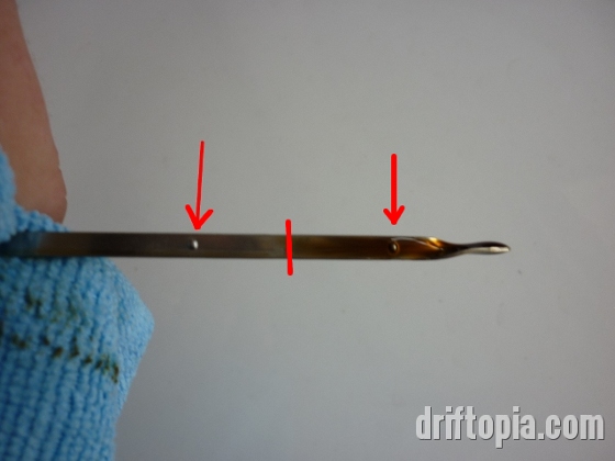 Note the two dimples on the dipstick used to indicate the oil level.  The red line marks where my oil level was after filling.  
