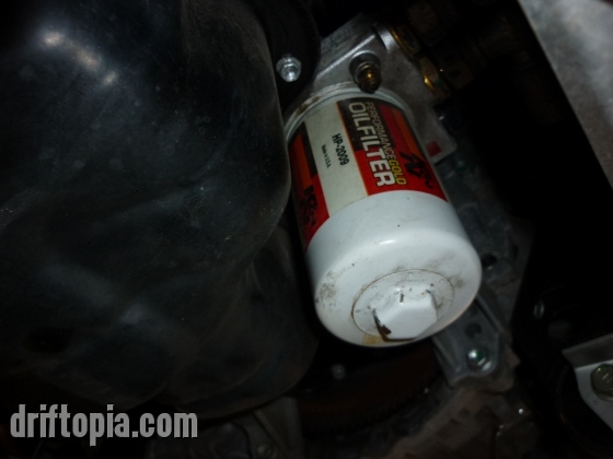 The oil filter is located right next to the oil pan on the firewall side of the engine.