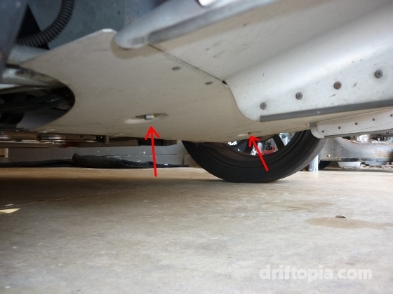 The 2 13mm bolts on the underside of the rear splitter.