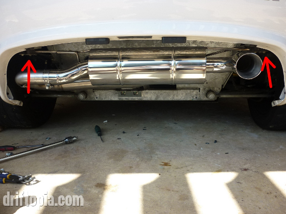 After sliding the muffler onto the decat, rotate the muffler upwards and reconnect the new muffler to the rear subframe.