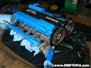 The cylinder head, valve covers, lower manifold and fuel rail installed on the freshly built CA18DET. 