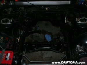 The empty engine bay of a 240sx after the ka24de motor was removed.