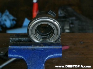 Using a table clamp to remove the old throwout bearing