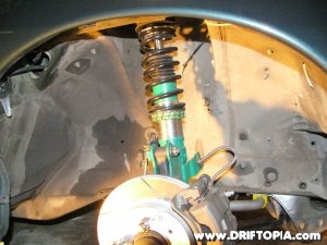 The front coilovers installed on the s13.
