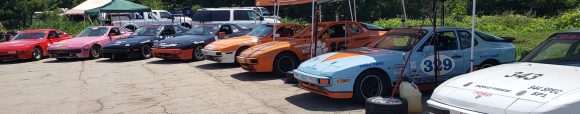 8 944 Spec racecars lined up at the Road Atlanta Paddock