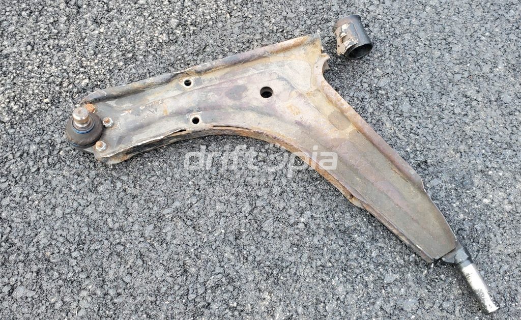 Showing where the torn bearing belongs on the Porsche 944 control arm.