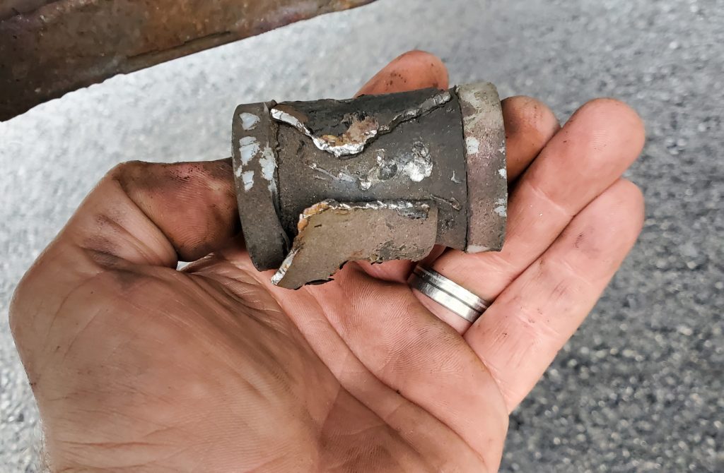 The bearing from the torn steel control arm of the Porsche 944 Spec.